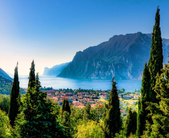 Foto vom Gardasee mit einer Stadt und den Bergen